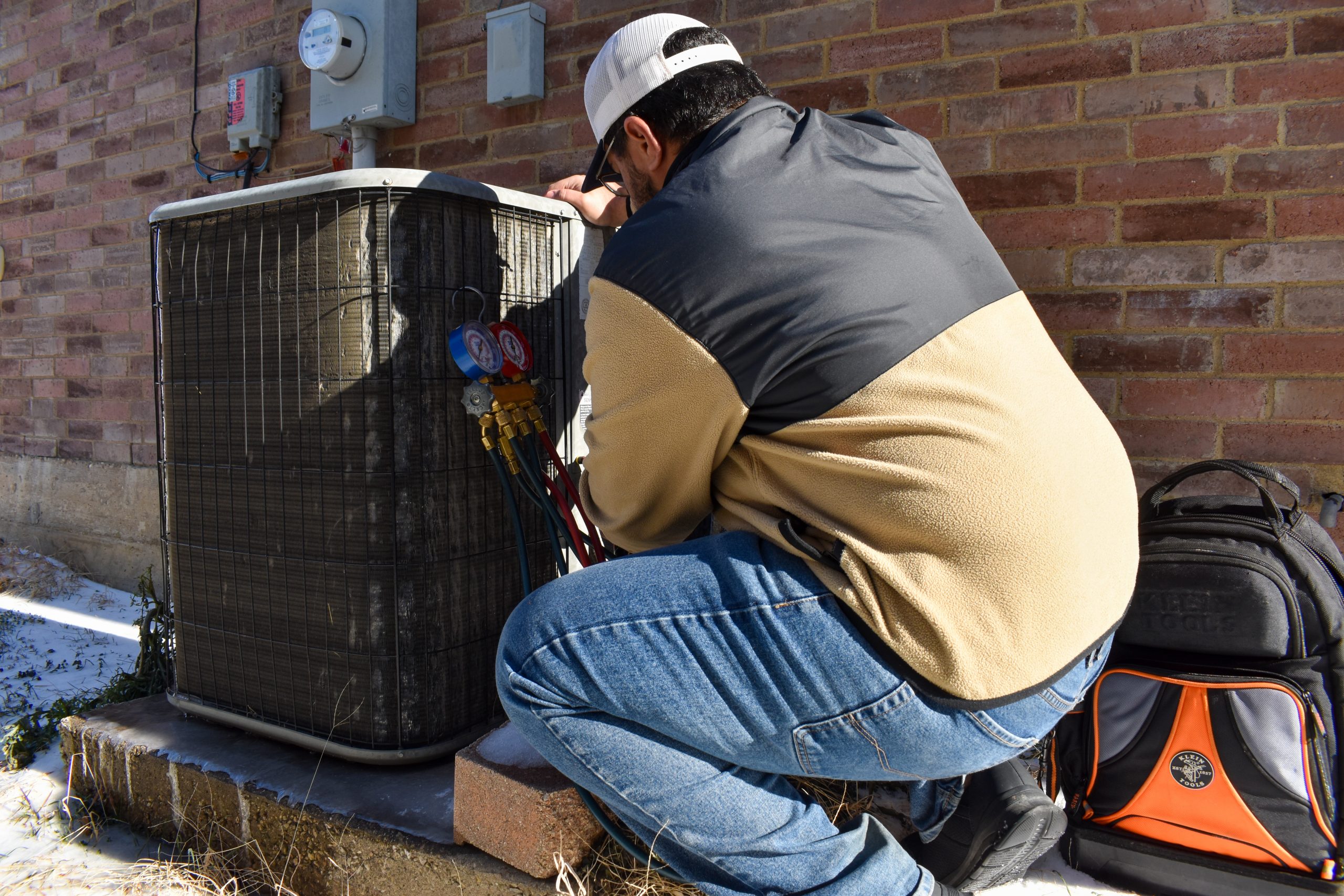 HVAC technician repairing refrigerant leak in Fort Worth TX