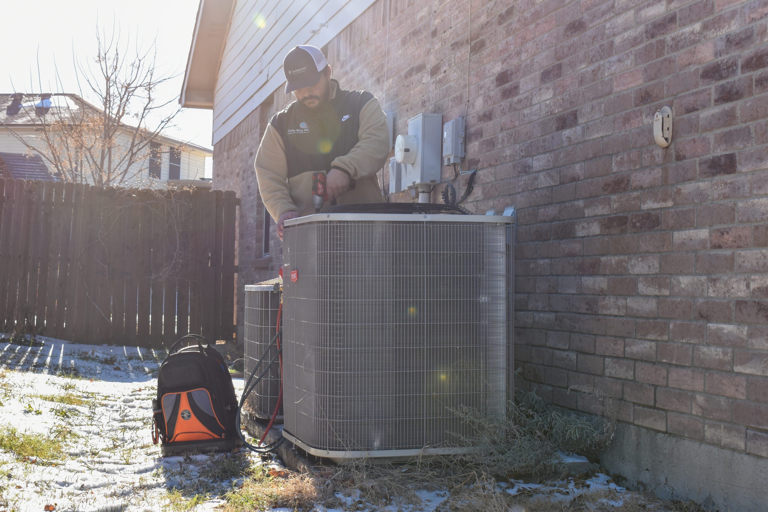 Technician evaluating uneven cooling in a two-story DFW home